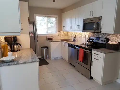 Professionally renovated, bright, freshly painted, 3-bedroom main floor suite located on a quiet, tr...