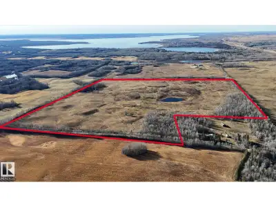 150 ACRES of raw land with dugout and pond, FENCED and CROSS FENCED pasture for cattle. Treed-lined...