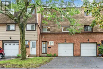 Updated 3-bedroom townhome with a standout cathedral-ceiling living room and dining room overlooking...