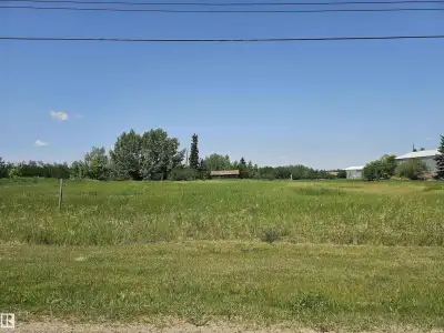 Discover the perfect canvas for your dream home or hobby farm on this 12.9-acre parcel in Tofield. T...