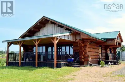 This home built in 2016 with massive logs (five of them make up a wall!) faces the Margaree River es...