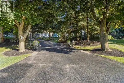 Set on a beautifully secluded two-acre property, this exceptional walk-out bungalow offers an elegan...