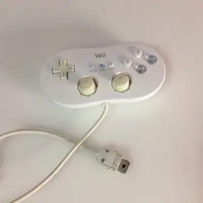 Genuine Nintendo Wii Classic Controller It plugs into a Wii Remote for connectivity. It features dua...