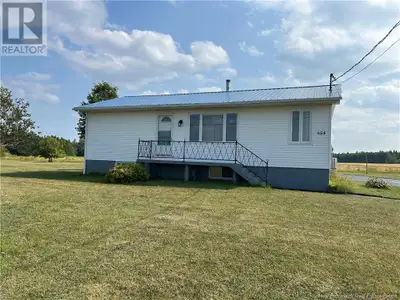 Une maison située sur la route 355 à Sainte-Rose sur un grand terrain avec un grand garage avec un d...