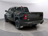The 2026 Ram 1500 Rebel 4x4 Crew Cab in a striking black hue offers a commanding presence on any ter... (image 2)