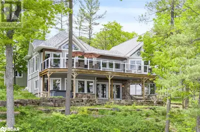 LIVE THE WATERFRONT LIFESTYLE ON STONEY LAKE - 200 FT OF PRIME WATERFRONT, BOATHOUSE, & SANDY BEACH!...