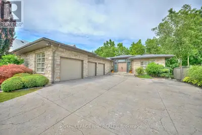 Tucked away in a secluded cul-de-sac on a ravine lot, this sprawling executive bungalow provides lux...