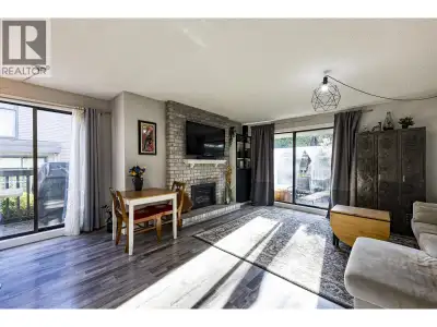 Inviting three level townhome (one of the largest in the complex) offers a bright kitchen with Caesa...