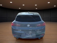 The 2022 BMW X2 xDrive28i Sports Activity Coupe in a sophisticated black finish and equipped with BM... (image 6)