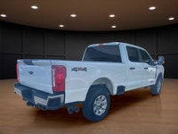 The 2023 Ford Super Duty F-250 SRW XLT in striking white comes equipped with a robust 4x4 drivetrain... (image 4)