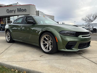 Introducing the dynamic 2023 Dodge Charger Scat Pack 392 Widebody in a striking green, complemented... (image 6)