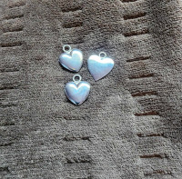 Charms, metal, two puffy half inch and one flat three quarter in