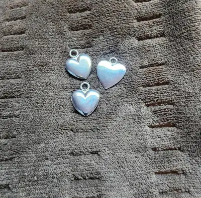 Charms, metal, two puffy half inch and one flat three quarter inch, $5.00 each