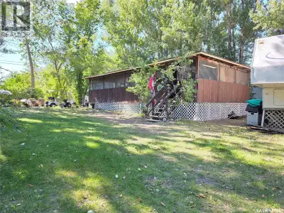 Welcome to this charming corner lot property at Coteau Beach on Lake Diefenbaker! Nestled among matu...
