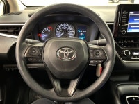 Dawn paints the streets in quiet silver as the 2021 Toyota Corolla L slips from the curb, its LED be... (image 9)