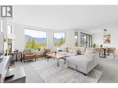 Indulge in breathtaking mountain vistas from every expansive vantage point of this open concept, bea...