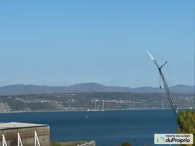 Vue sur le fleuve grand garage double intégré entrée et garde-robe (plancher chauffant en porcelaine...