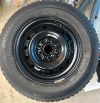 Set of 4 Bridgestone Blizzak M+S tires on rims. 215/65R15