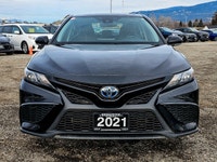 Experience the refined elegance of the 2021 Toyota Camry in its sophisticated black finish and effic... (image 2)