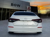 The 2025 Honda Civic Sedan Hybrid Sport in a stunning white finish combined with its FWD drivetrain... (image 5)