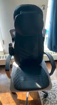 Ergonomic chair with detachable massage pad.