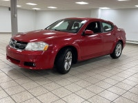 A red 2011 Dodge Avenger SXT easing through the day has a way of making routine driving feel more de... (image 1)