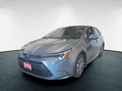 The 2023 Toyota Corolla Hybrid LE in stunning gray, boasts a fuel-efficient FWD drivetrain known for...