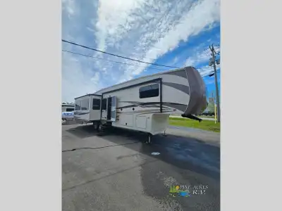 This triple slide Cedar Creek Hathaway Edition 36CKTS fifth wheel by Forest River offers spacious li...