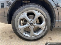 The 2024 Ford Escape ST-Line in sleek black boasts AWD capabilities, making it a versatile and relia... (image 5)