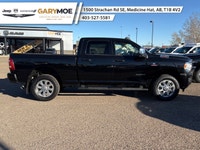 The 2023 Ram 2500 Laramie, in a striking black finish and equipped with a robust 4x4 drivetrain, pro... (image 1)