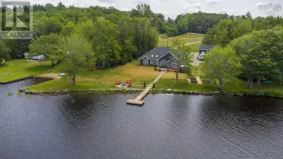 Commanding a prime position along the shores of Journeays Lake, this 2020-built waterfront home deli...