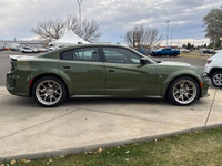 Introducing the dynamic 2023 Dodge Charger Scat Pack 392 Widebody in a striking green, complemented... (image 5)