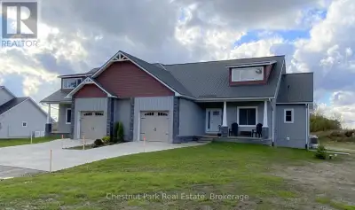 This Craftsman design features a covered main entry porch leading to an open concept floorplan displ...