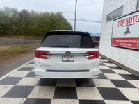 A spacious family minivan with comfortable seating, advanced safety features, and practical convenie... (image 4)