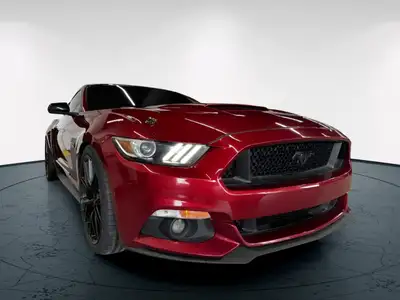 The 2016 Ford Mustang GT in vibrant red with a rear-wheel-drive setup promises dynamic handling and...