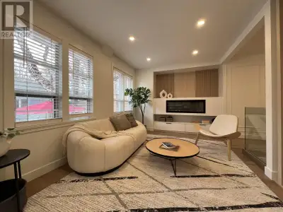 This stunning renovation transformed a dated one-story family home into a sleek, modern open-concept...