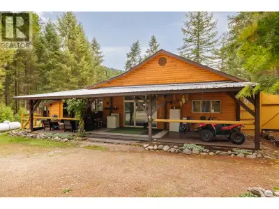1.9-acre corner lot featuring a log rancher fully fenced, perfect to call home or use as a vacation...