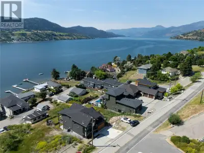 Stunning Okanagan lake view property with income stream awaits. Impressive 4 bed, 2 1/2 bath impecca...