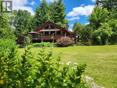 Escape to the beauty of Shuswap Lake with this semi-waterfront 3-bedroom, 2-bath log cabin in the pe...