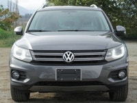 The 2012 Volkswagen Tiguan Highline in its sophisticated gray hue, paired with an agile AWD drivetra... (image 5)