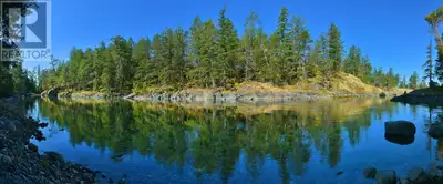 A rare and extraordinary opportunity to own more than 5 waterfront acres bordering hundreds of acres...