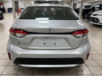 Dawn paints the streets in quiet silver as the 2021 Toyota Corolla L slips from the curb, its LED be... (image 4)