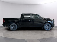 The 2026 Ram 1500 Big Horn, presented in a commanding Black finish and equipped with a robust 4x4 dr... (image 5)