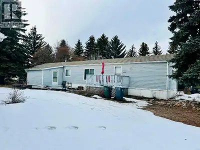 Spacious mobile home on a quiet street with beautiful mature trees, established perennials, and a ma...