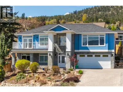 Perched to capture panoramic lake views from every level, this impressive 2011 custom-built home off...