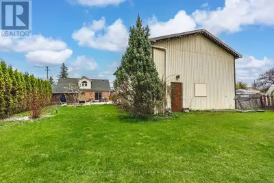 HIGH-TRAFFIC LOCATION WITH C2 ZONING, A DETACHED WORKSHOP/GARAGE, & A 1.5-STOREY HOME! Build your bu...
