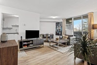 Fully renovated spacious suite features kitchen with modern features and finishes including laminate... (image 2)