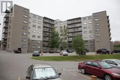 Welcome to this deluxe 2-bedroom unit featuring an open-concept kitchen with dark cabinetry and stai...