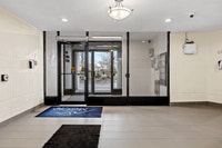 Fully renovated spacious suite features kitchen with modern features and finishes including laminate... (image 6)