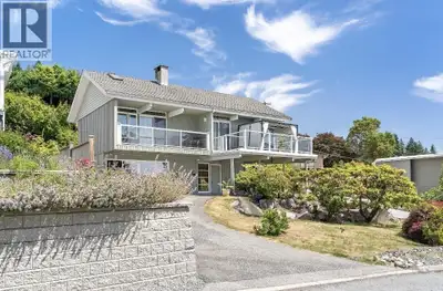 Perched on a beautifully landscaped corner property, this timeless post and beam home captures stunn...